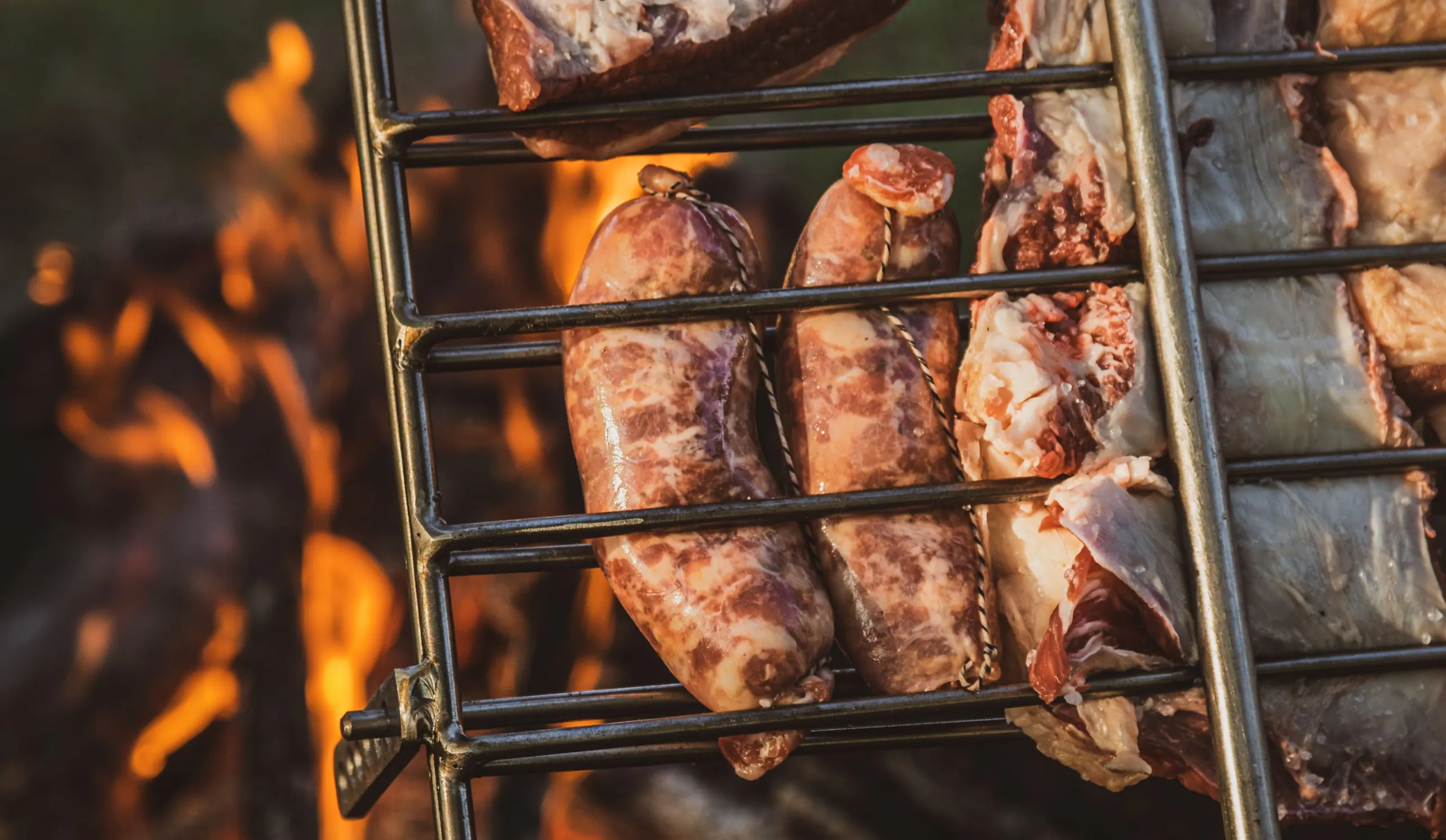 Ribs and chorizos on a Sostiene asador over an open fire