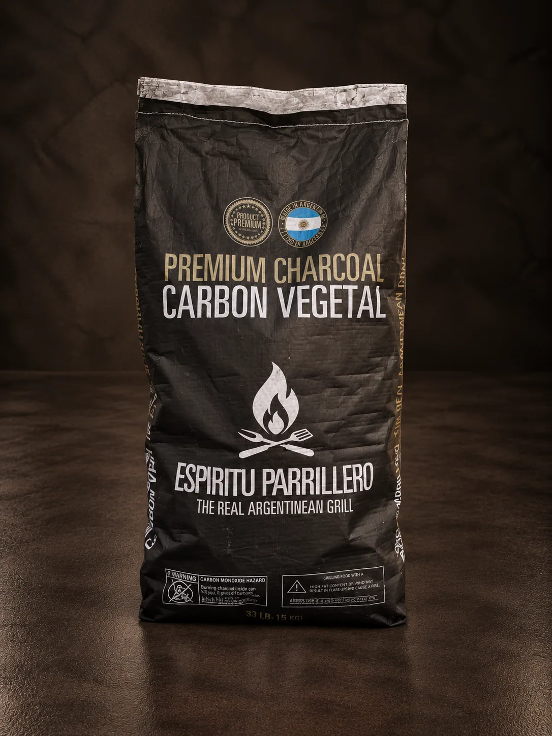 A bag of Espíritu Parrillero premium charcoal, on dark stone