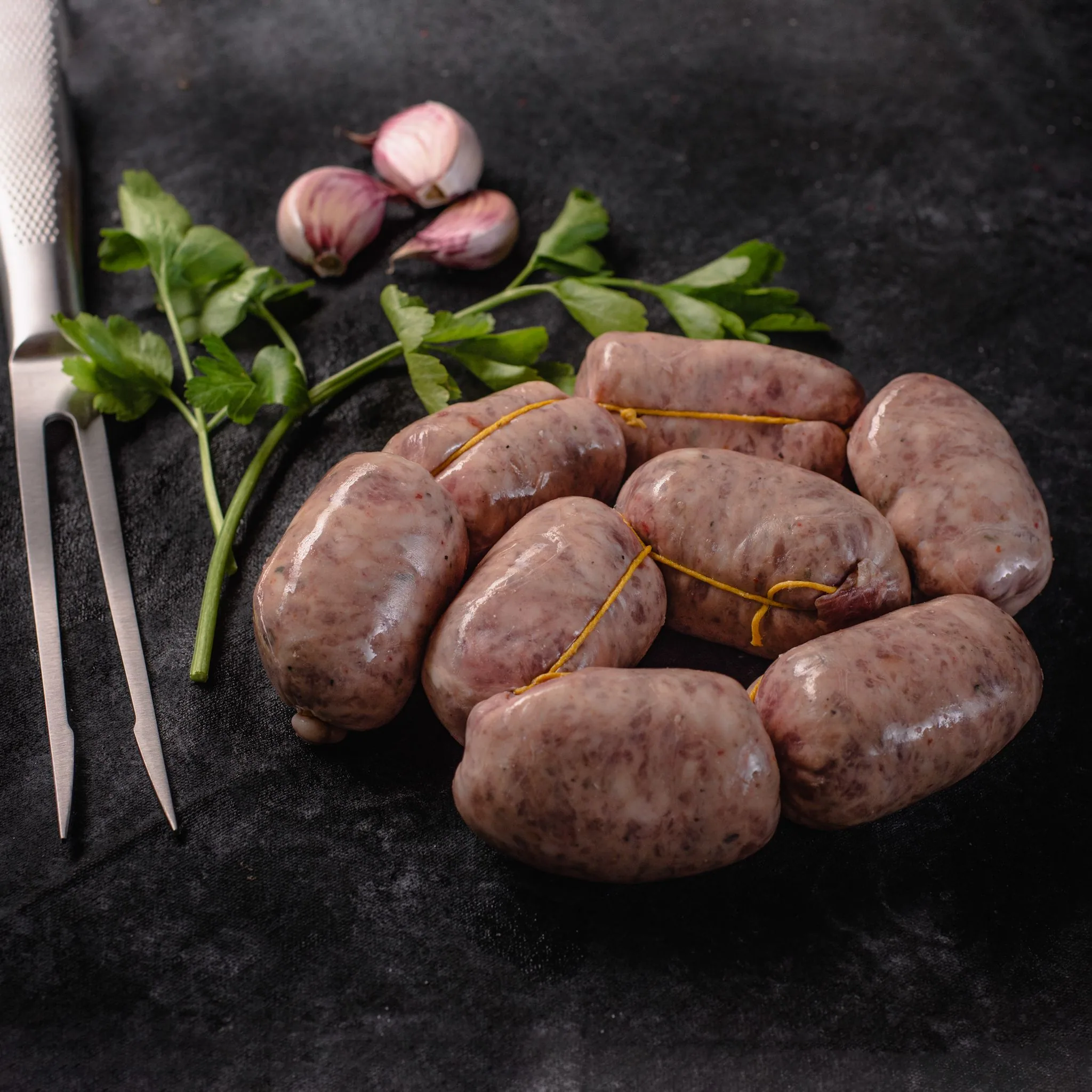 Argentine chorizo bombón sausages, on dark stone
