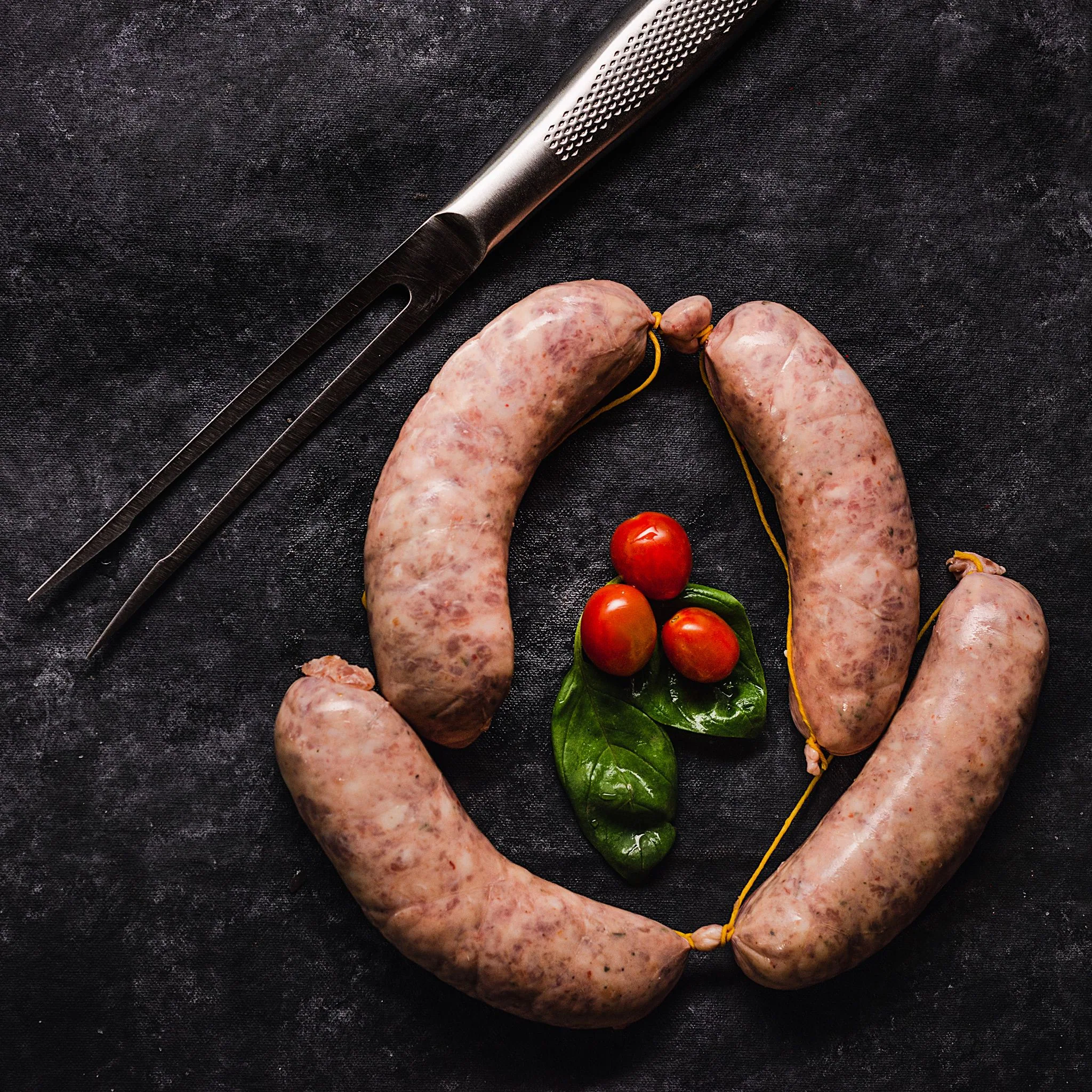 Argentine chorizo sausages, on dark stone