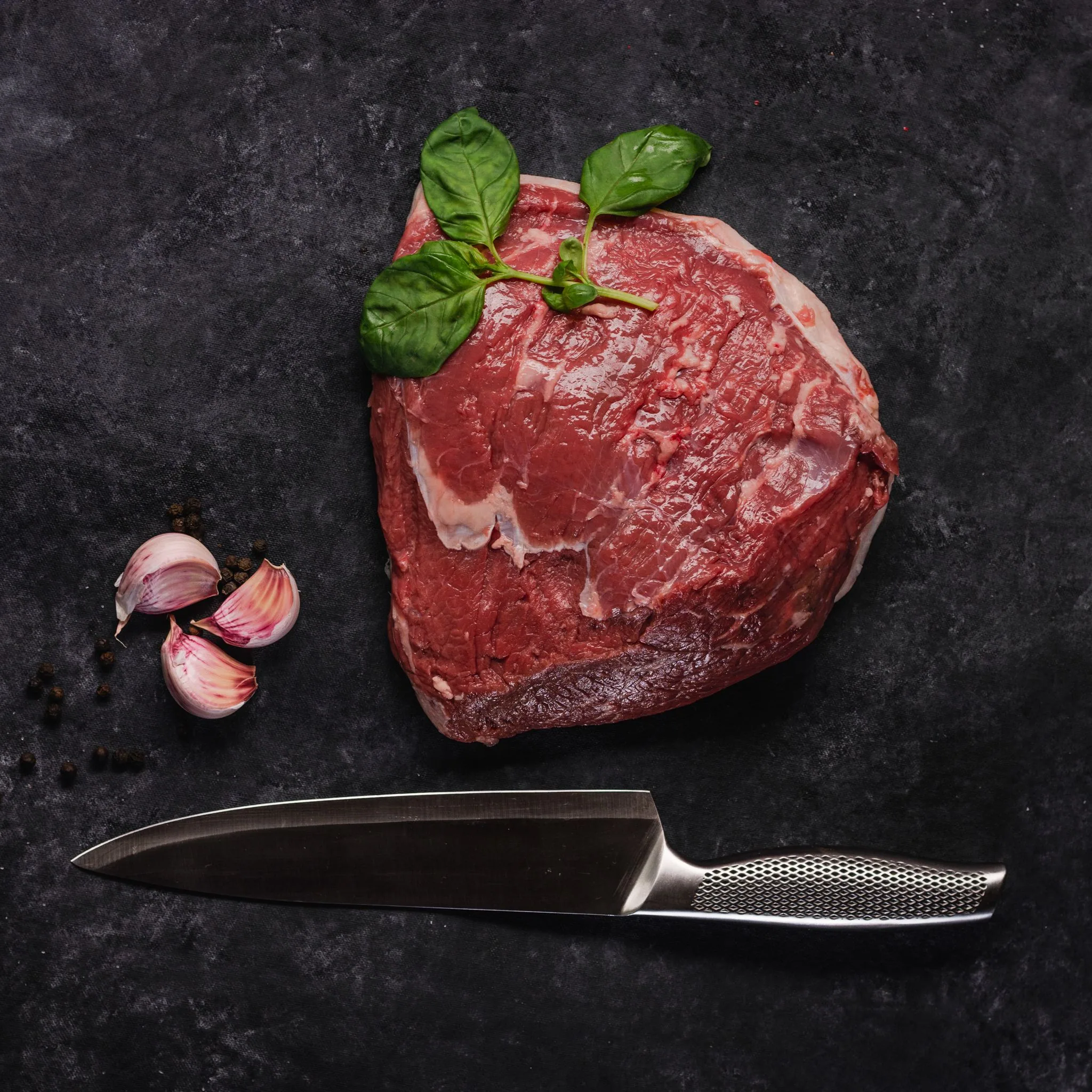 An Argentine Angus picanha, on dark stone